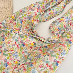 Detail of floral tote bag with colorful small flower pattern and cute ribbon bow tie