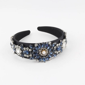 Detailed view of Baroque headband with blue crystals and centered faux pearl ornament