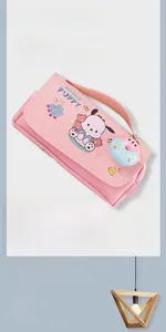 Detailed view of pink oxford fabric pencil case with cartoon dog and donut pendant