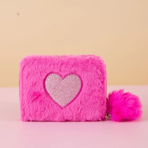 Detail of pink faux fur coin purse featuring a glitter heart and fluffy pom-pom charm