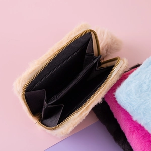 Detailed view of plush coin purse interior showing accordion compartments and soft faux fur