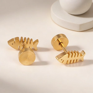 Polished gold stainless steel fishbone screw back earrings on a minimalist pedestal
