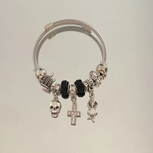 Gothic steel wire bracelet featuring skull charms, cross pendant and crown detail