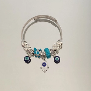 Detail of Hamsa Hand and Evil Eye charms on a beaded twisted rope bangle bracelet