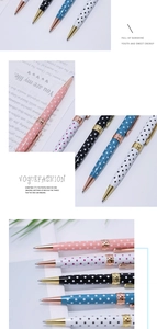 Close-up of stylish polka dot metal ballpoint pens with elegant gold clip and accents
