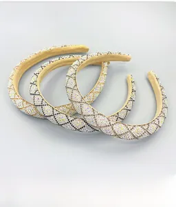 Close-up of champagne rhinestones headband with elegant black diamond lattice pattern