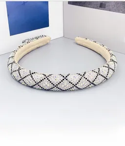 Detail of luxury padded headband with crystal rhinestones and geometric diamond patterns