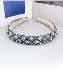 Macro detail of rhinestone diamond lattice pattern on the padded wide headband
