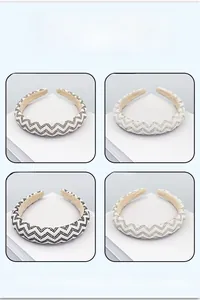 Detail of four beaded rhinestone headbands featuring wave patterns in assorted colors