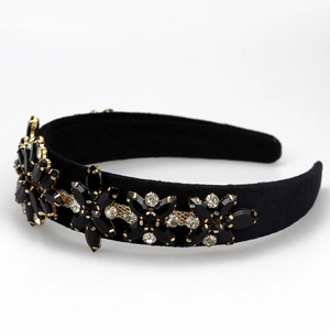 Detail of sunflower rhinestone embellishments on a black velvet baroque headband
