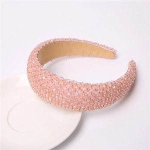 Detailed view of pink crystal beads on a wide sponge headband with soft non-slip lining