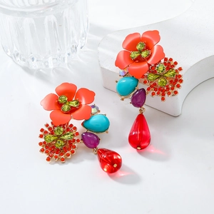 Close-up of vintage floral earrings with colorful resin petals and teardrop crystals