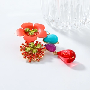 Detailed close-up of retro floral earring with colorful resin beads and rhinestones