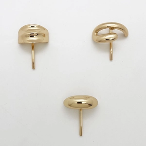 Detailed view of three minimalist gold metal hair hooks with varied geometric textures