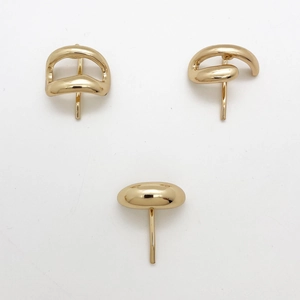 Close-up of golden irregular streamlined metal hair clips with mirror polished finish