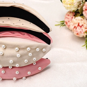 Detail showing knotted wide headbands with honeycomb texture, pearls, and small rhinestones