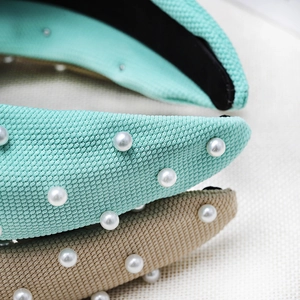 Detail of mint green and khaki knitted headband with pearls and non-slip lining