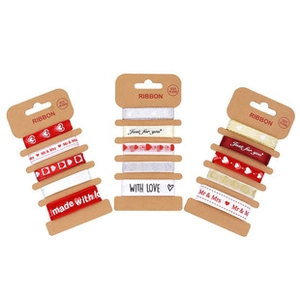 Close-up of red and white heart printed ribbons with festive Just for you greetings