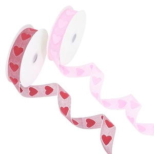 Detail showing two rolls of heart patterned ribbons in red and pink with ribbed texture