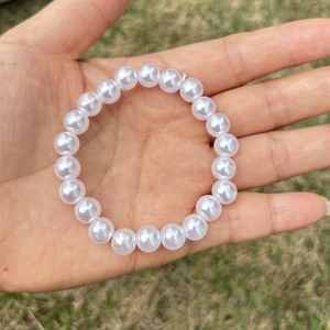 Detailed view of elastic faux pearl beaded bracelet for girls on a natural background
