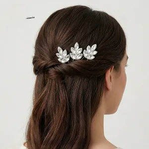 Detailed view of elegant silver leaf hair pins with crystal rhinestones in bridal hair