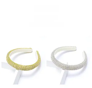 Detail of crystal embellished headbands in gold and silver with shimmering rhinestones