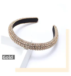 Close-up of wide headband featuring layered gold rhinestones and black inner lining