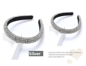 Detailed view of silver thick headband with densely paved glittering rhinestones and velvet lining