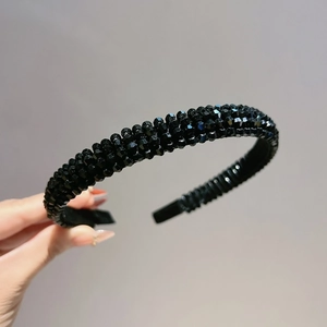 Close-up of four-row black crystal headband with sparkling faceted beads and fabric edging
