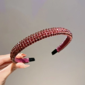 Detail of handmade sparkling burgundy crystal beads on a flexible non-slip headband