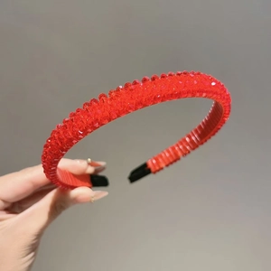 Detailed close-up of vibrant red crystal beaded headband with non-slip black end tips