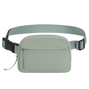 Detailed macro view of green waterproof Oxford fabric and zipper on the sports waist bag