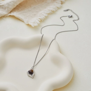 French style stainless steel necklace featuring a heart-shaped tiger eye stone pendant