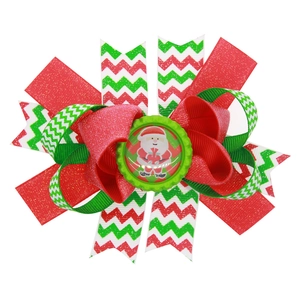 Handmade Christmas bow hair clip with Santa Claus charm and green glitter ribbon