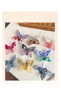 Collection of nine acetate butterfly hair claw clips in various marbled floral patterns