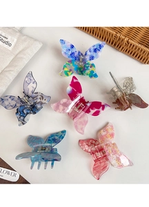 Detailed close-up of six butterfly hair clips with marble texture on a white background