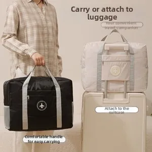 Waterproof travel bag with trolley sleeve and reinforced handles in black and beige