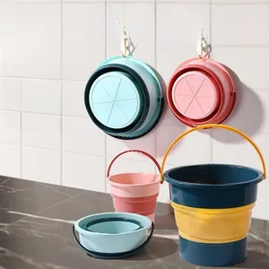 Detail of pink and blue folding buckets made of PP and TPE with wall hanging handle
