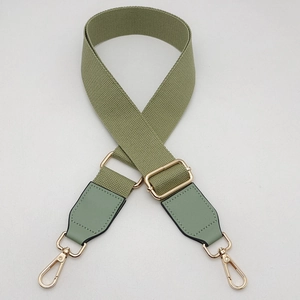 Adjustable sage green canvas shoulder strap with gold metal buckles and leather ends