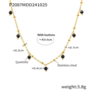 Close-up of 18K gold plated necklace featuring black quartzite beads and metal spheres