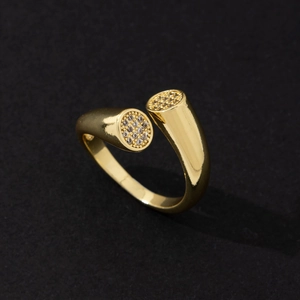 Close-up of minimalist golden open ring with shimmering micro-pave stone detail