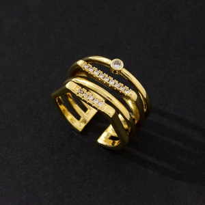 Detailed macro view of an elegant multi-layer gold-plated ring set with zircon stones