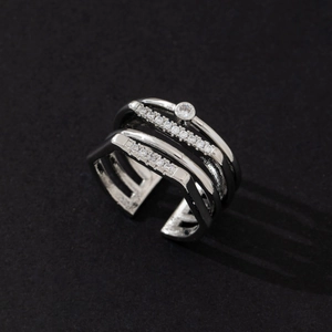 Macro view of a silver multi-layered ring featuring sparkling paved stones and single gem