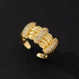 Close-up of golden open ring featuring sparkling micro-pave cubic zirconia stones.