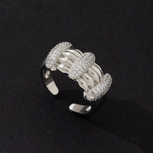 Detailed view of silver-tone multi-band ring encrusted with clear stones