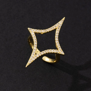 Detailed macro view of a gold-plated star ring with shimmering zirconia stones