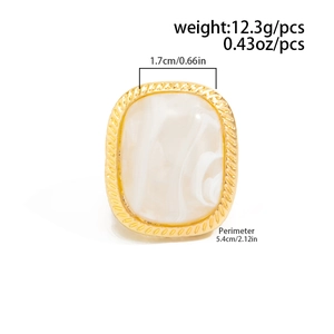 Detail of gold metal ring featuring a large marble stone inlay and size specifications