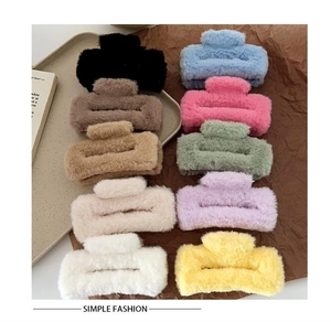 Macro shot of 10 colorful plush square hair claws in soft faux fur for women