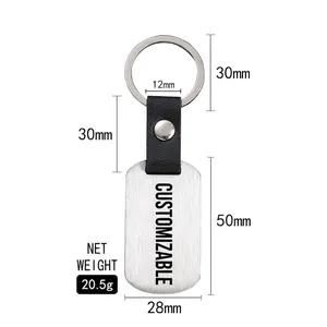Steel football keychain with black leather strap and rectangle plate on white background