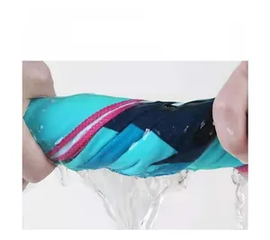 Close-up showing the absorbent quick-dry fabric being wrung out with water droplets